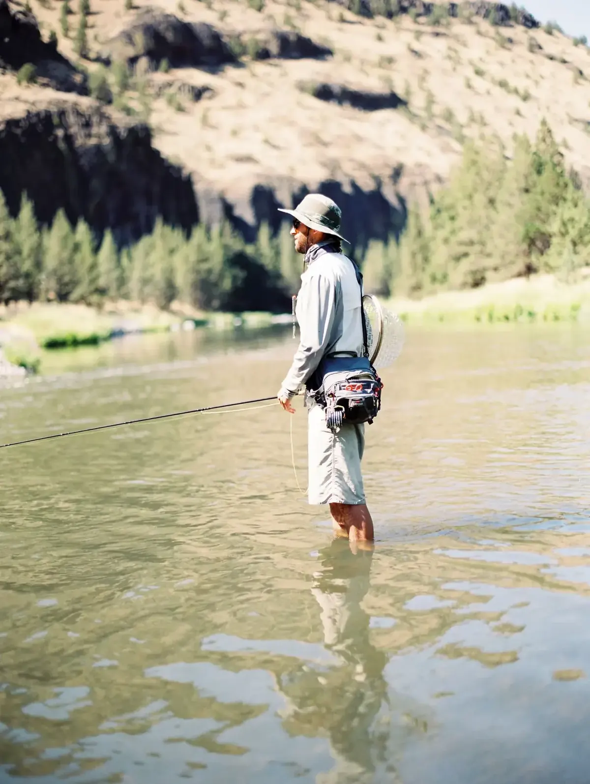 Angler standing carefully in shallow water