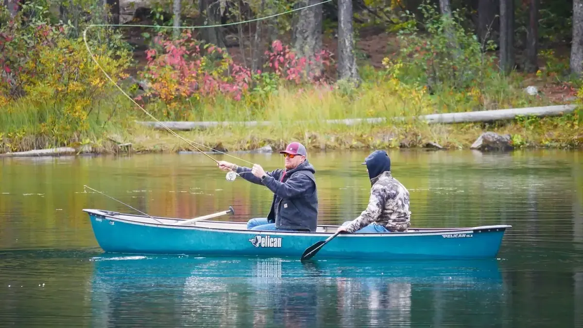 Two people fishing from a canoe