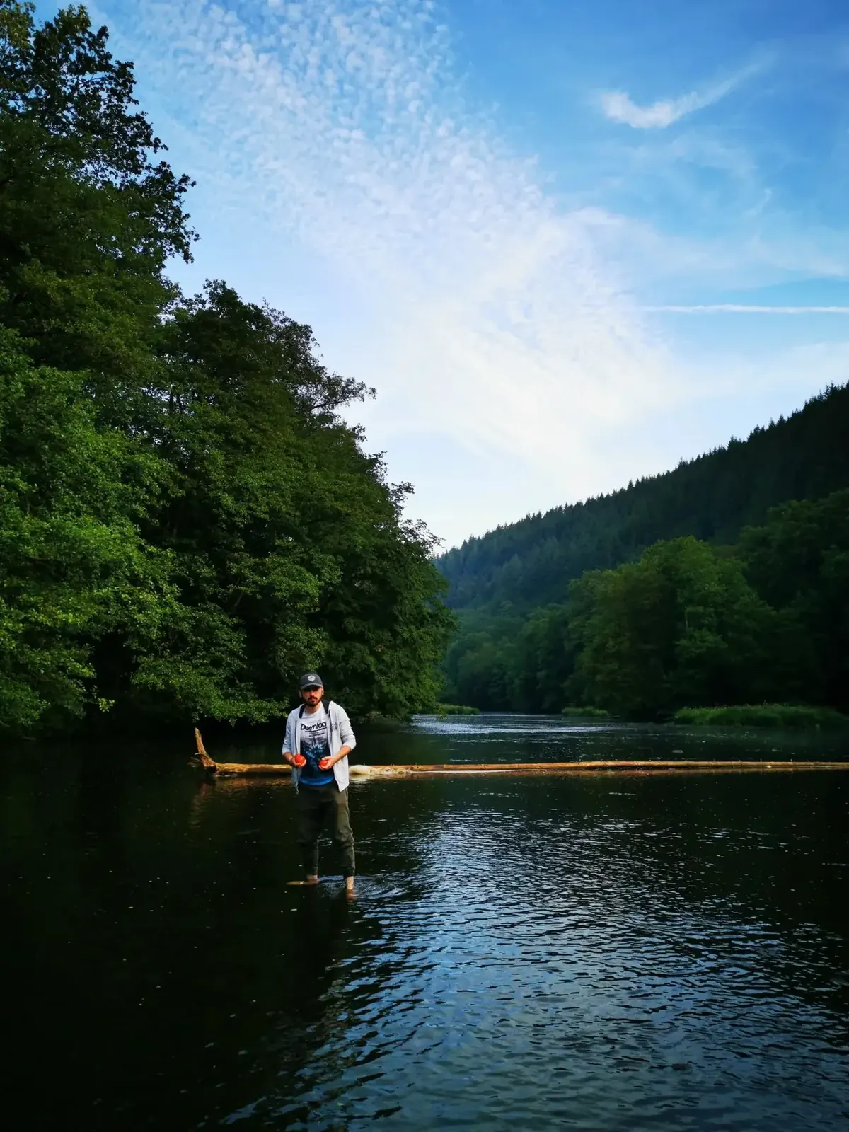 Angler fishing from a quiet lake shoreline