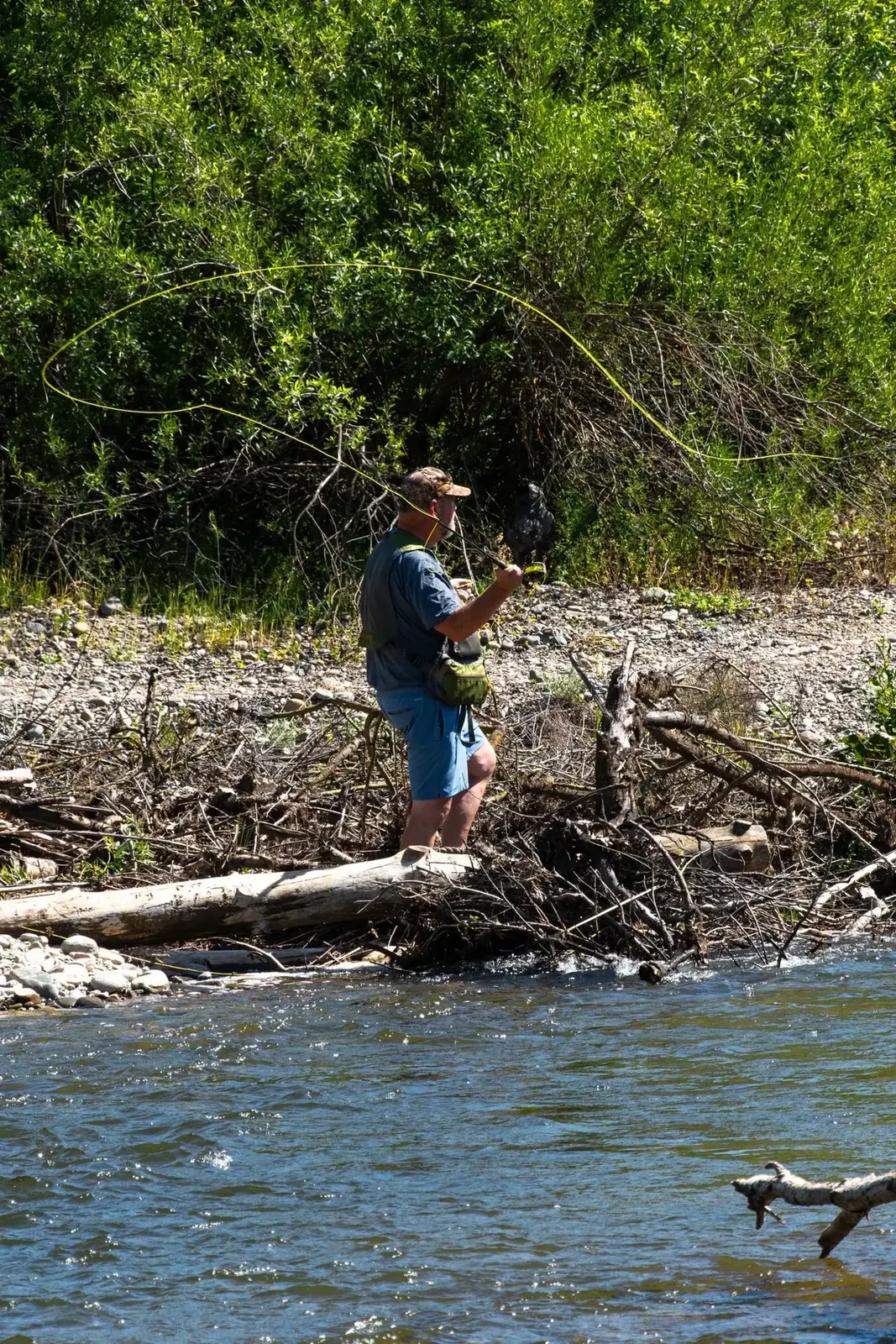 Angler fishing a narrow river channel